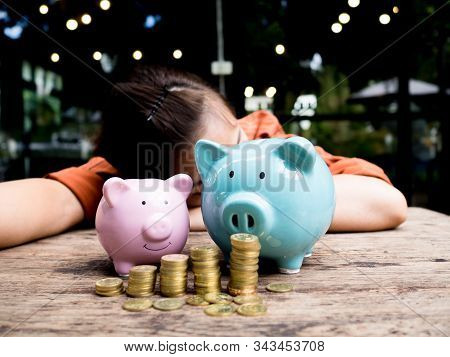 Business Woman Relaxing Behind Two Piggy Bank With 
Gold Coins Pile Growth Graph, Saving Money For F