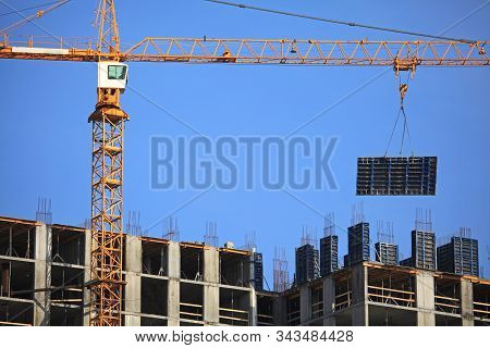 Сonstruction Crane  With Formwork Shield At The Construction Of Monolithic Apartment Building. Build
