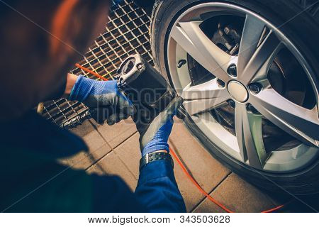 Vehicle Tires Replacement And Wheels Balancing. Automotive Industry.