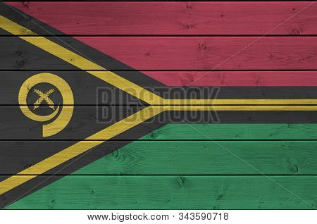 Vanuatu Flag Depicted In Bright Paint Colors On Old Wooden Wall. Textured Banner On Rough Background