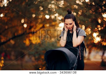 Exhausted Mother Having Headaches Pushing A Baby Stroller