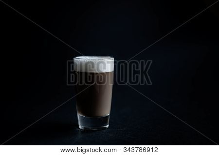 Mini Cup Of Cappuccino In A Glass Cup On Black Background