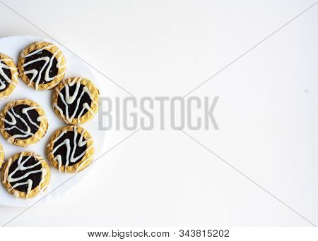 Cookies With Chocolate And White Icing. Top View, Copy Space