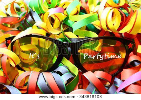 The Picture Shows Glasses With The Text It`s Partytime And Paper Streamers