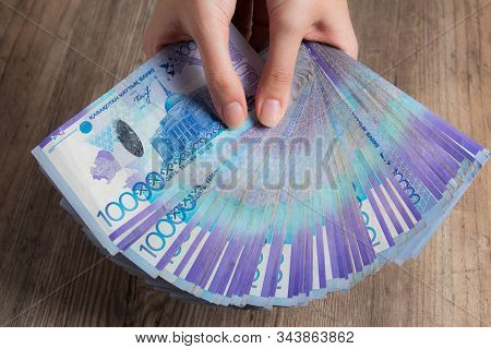 Hands Hold A Lot Of Money. Tenge Kzt. National Currency Of Kazakhstan, Kz. Exchange Rate. Economy, D