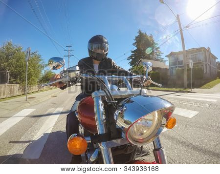 Vancouver, British Columbia, Canada - July 08, 2018: Man On A Motorcycle Is Riding In A Modern City 