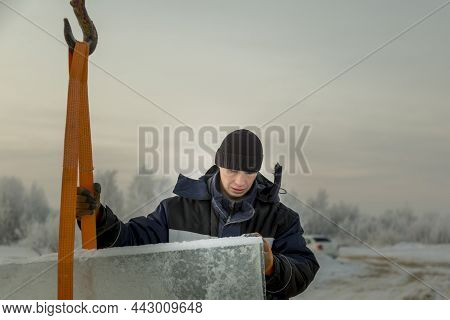 Portrait Of A Worker In A Black Hat Unloading