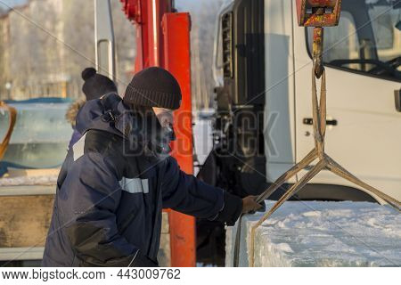 Portrait Of A Worker In A Black Hat Unloading
