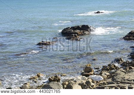 Rocks On Sea Water In Mijas Beach, Malaga, Andalusia, Spain.
