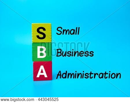 Colored Wooden Cube With Word Sba On A Blue Background.