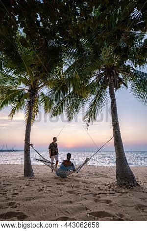 Najomtien Pattaya Thailand, Hammock On The Beach During Sunset With Palm Trees. Couple Man And Woman