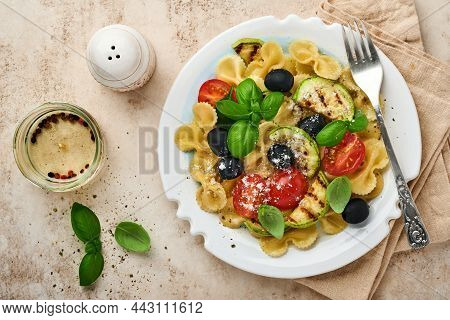 Pasta Fiocchi Salad With Vegetables Grilled Zucchini, Cherry Tomato, Olives, Basil And Parmesan Chee