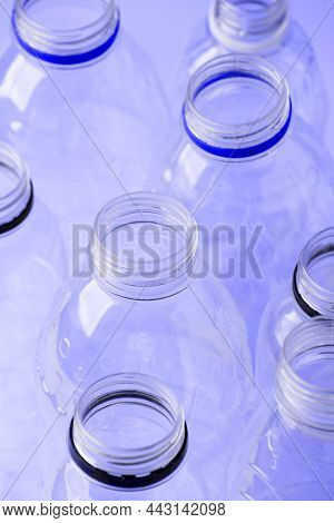 Set Of Diverse Used Empty Water Plastic Bottles Without Caps On Trendy Background. Concept Of Recycl