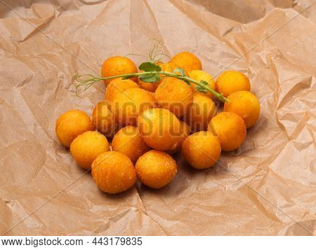 Tatsy Deep-fried Cheese Or Potato Balls On Craft Paper