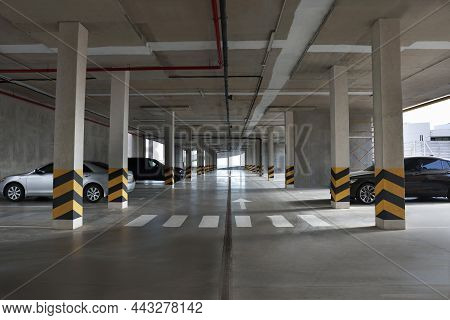 Modern Cars In Parking Garage With Pedestrian Crossing