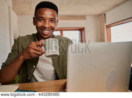 Portrait Of Young Adult Black Male Holding Morning Coffee, Smiling At Camera. Working Remotely In Mo