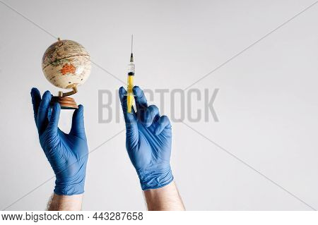 Symbol Of Health Insurance On A Global Scale. Hands In Medical Gloves With A Syringe On A White Back