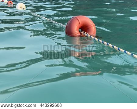 Beach Buoys On A Rope In The Sea. A Marker For Swimming In Blue Water. Concept: Swimming In The Warm