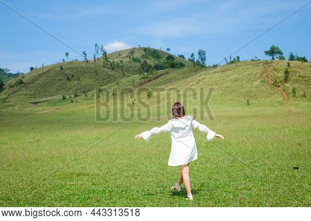 Beautiful Girl Stand And Acting In Front Of Bald Mountain Or Phu Khao Ya With Green Grass Field And 