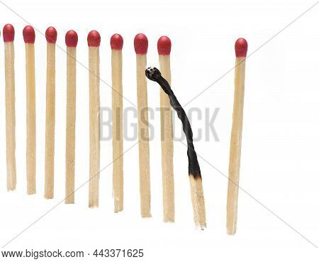Close Up Of Matches In An Even Row With A Burned Match Behaving Differently Than Concept For Burnout