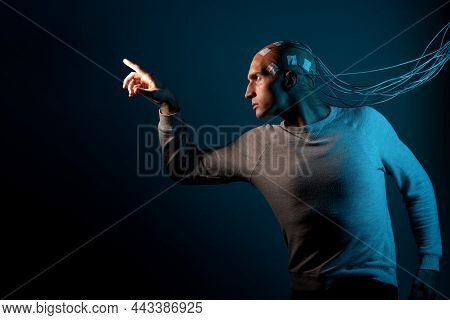 A Young Man With His Head Entangled In Wires, Pulls His Hands Forward, Electrical Contacts On His Ba