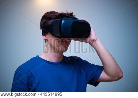 An Excited Young Guy In Virtual Reality Glasses Is Immersed In The Metaverse