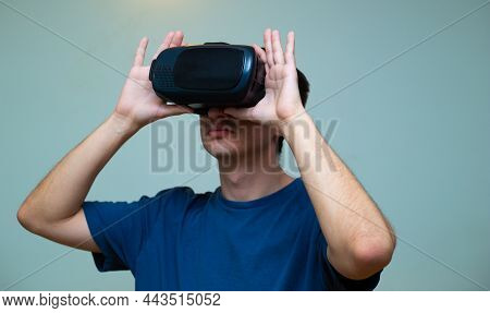 An Excited Young Guy In Virtual Reality Glasses Is Immersed In The Metaverse