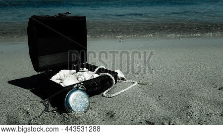 A Pirate Treasure Chest On A Sandy Beach.a Treasure Trove Of Seashells, Antique Watches And Jewelry 