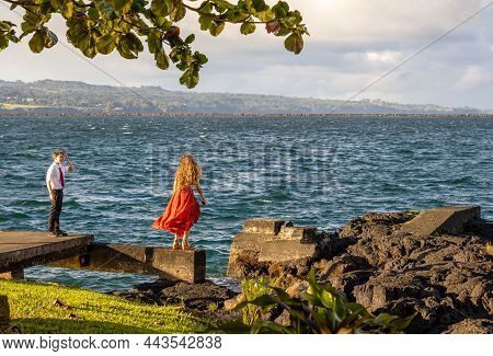 Hilo, Hawaii - November 28, 2021: Two Teenagers Enjoying The Ocean View From The Pier Of Reeds Bay B