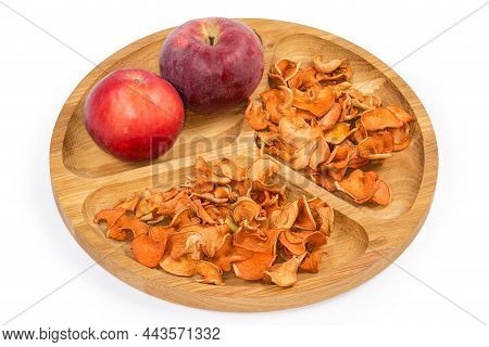 Dried Thin Slices Of Apples And Two Whole Fresh Red Apples On The Wooden Compartmental Dish On A Whi