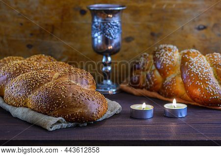 Shabbat Shalom - Challah Bread, Shabbat Wine And Candles On Brown Wooden Table.