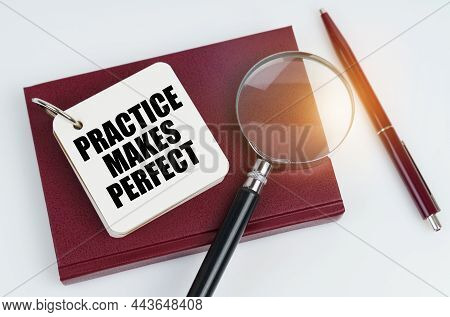 Business And Finance Concept. On A White Surface Lies A Red Notebook And A Pen, In The White Noteboo