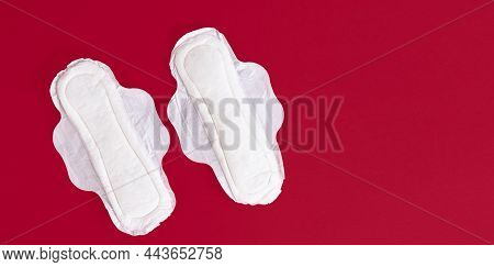 Two Feminine Sanitary Pads, Napkins. Feminine Hygiene Products During The Menstrual Cycle. Red Backg