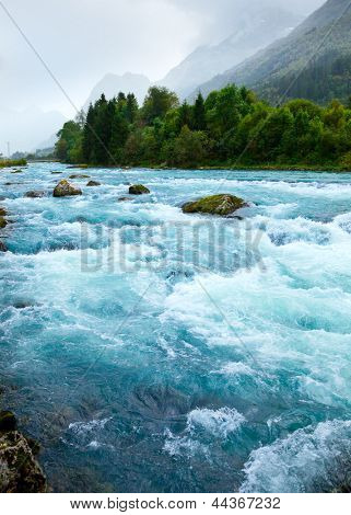 Milky blue glacial water of Briksdal River in Norway