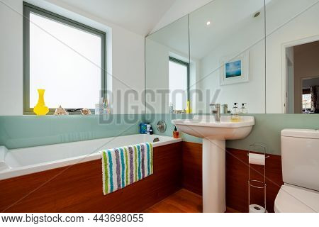 Clare, England - March 9 2020: Residential Domestic Shower/bathroom Room With Bottle Green Splashbac
