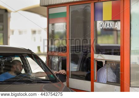 Giurgiu, Romania - July 1, 2021: Drivers Show The Border Police Officer Documents At The Land Border