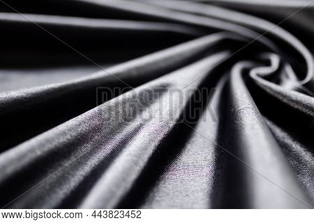 Luxurious Black Silk Satin Cloth Flat Lay Background. Black Abstract Smoot Rippled Fabric Stylish To