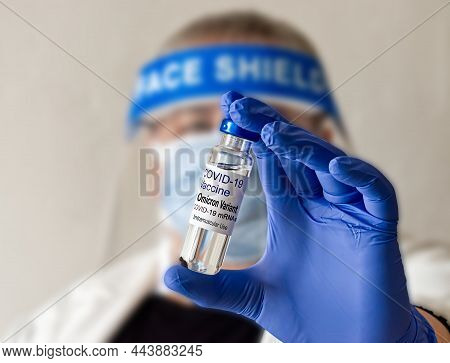 Selective Focus Doctor Hand Holding Vaccine Dose For Covid-19 Omicron Variant. Blurred Background. O