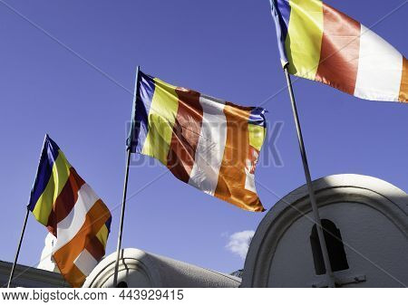 Waving Colorful Buddhist Sri Lanlan Flag In Cloudy Blue Sky Background