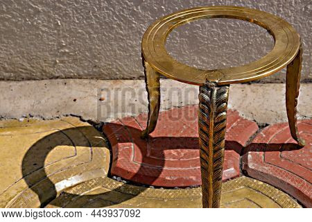 Stock Photo Of Ancient Style Handmade Brass Three Legged Ring Center Stand Or Stool Kept On Wall Und