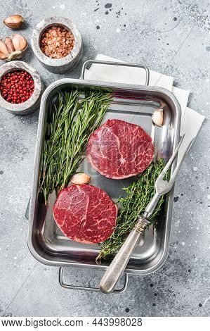 Raw Fillet Mignon Beef Steaks From Tenderloin. Gray Background. Top View
