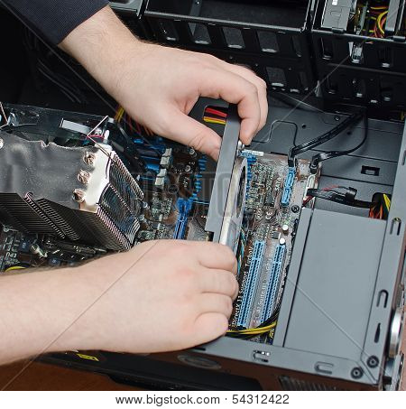 Hands Of Technician Installing Graphic Card