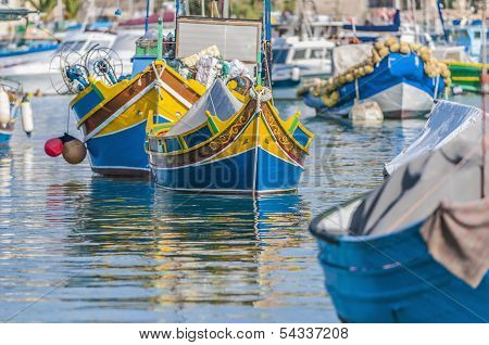 Traditional Luzzu Boat At Marsaxlokk Harbor In Malta.