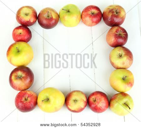 Juicy apples on white wooden table