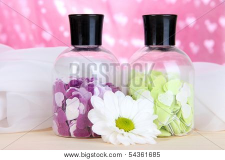 Aromatherapy minerals - colorful bath salt on pink background