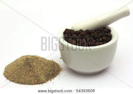 Finely Ground Pepper Beneath Whole Peppercorns