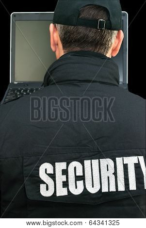 Security Working On Laptop, Over The Shoulder