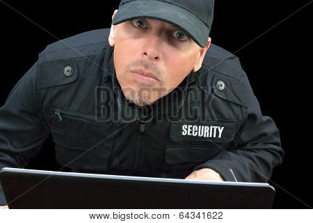 Security Working On Laptop, Looking To Camera