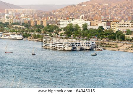 Nile River by Aswan City skyline with Boats