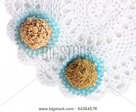 Chocolate candies with chopped nuts, isolated on white